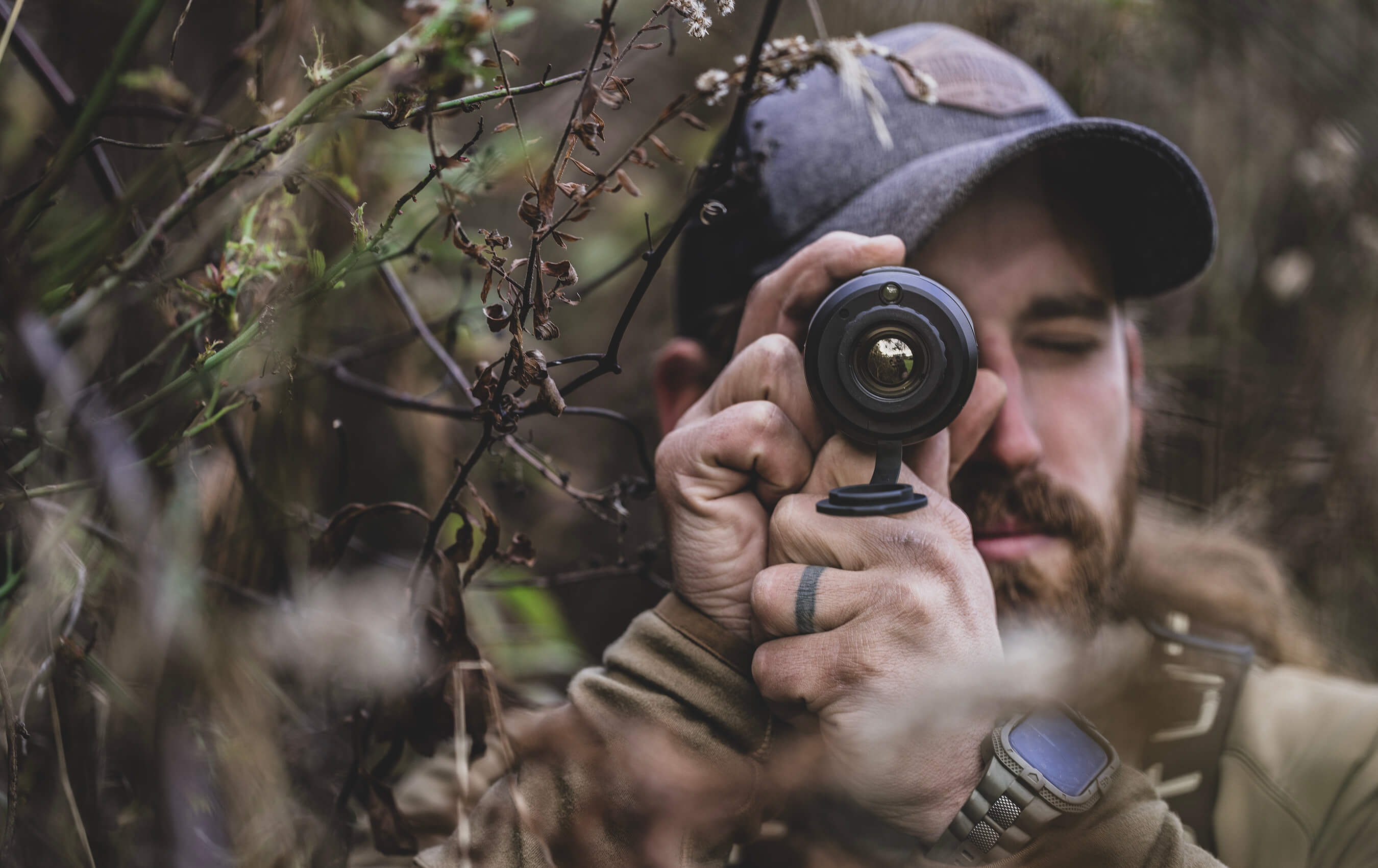 Hunter in the wild looking through a scope